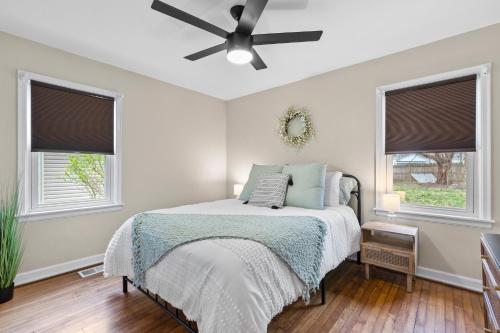 a bedroom with a bed and a ceiling fan at Isla's Landing in Lexington