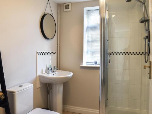 a bathroom with a toilet sink and a shower at Elm House Studio in Christleton