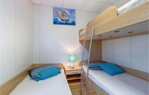 two bunk beds in a small room with a ladder at Amazing Home In Nerezine With Outdoor Swimming Pool in Nerezine