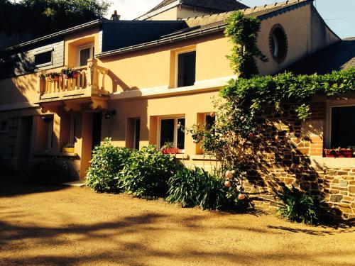 a large house with a balcony and a yard at Gite de la Renaissance, Binic , Bretagne in Binic