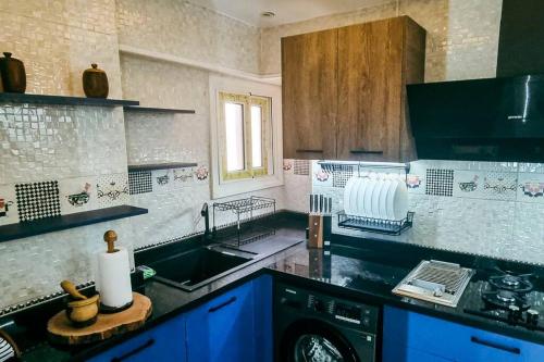 a kitchen with a sink and a washing machine at Luxury VIP apartment in Cairo