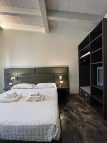a bedroom with a bed with two towels on it at Modus Aquae in Brisighella