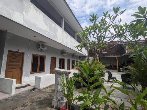 a courtyard of a house with plants at Rumah Pagar Merah Homestay in Yogyakarta