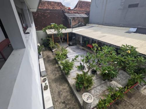 Rumah Pagar Merah Homestay في يوغياكارتا: اطلالة جوية على شرفة مع نباتات على مبنى