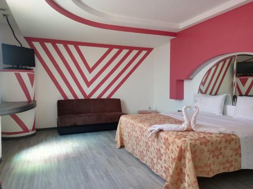 Una cama o camas en una habitación de Hotel Afrodita