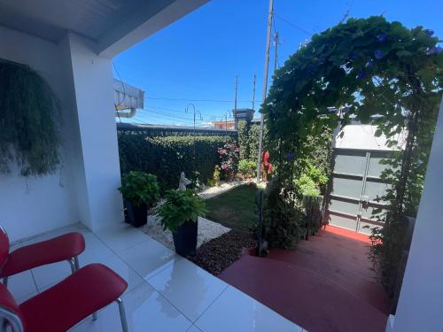 a balcony with a view of a garden at Alicia's Place 10 min from AirPort in Alajuela City