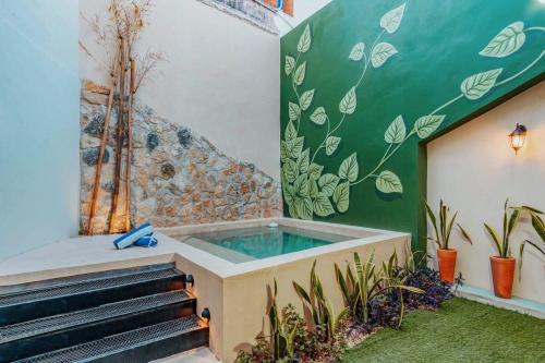 a jacuzzi tub in a room with plants at Ya ax nah Luxury house in downtown Mérida in Mérida
