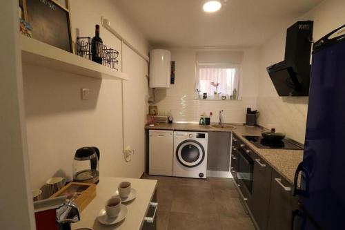 a small kitchen with a washing machine in it at Apartments with WiFi Sibenik - 20831 in Šibenik