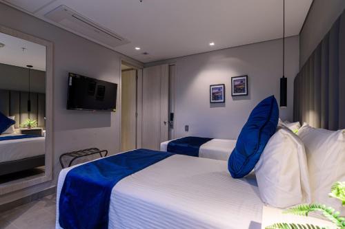 Postel nebo postele na pokoji v ubytování 4 Sur Hotel
