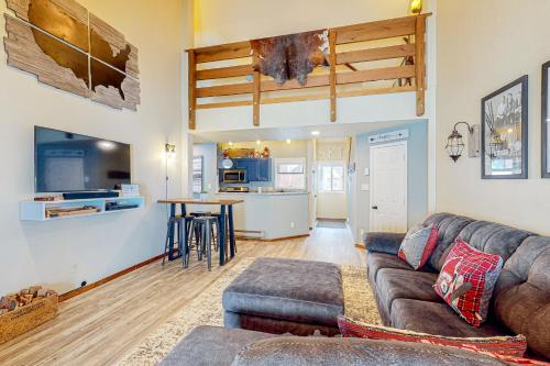 a living room with a couch and a kitchen at Durango Dreaming in Durango Mountain Resort
