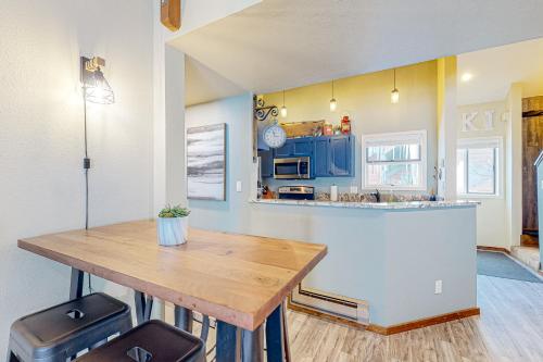 a kitchen with a wooden table and a counter at Durango Dreaming in Durango Mountain Resort