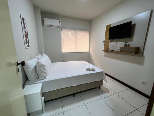 1 dormitorio pequeño con 1 cama y TV en Flat Píer Sul Ondina, en Salvador