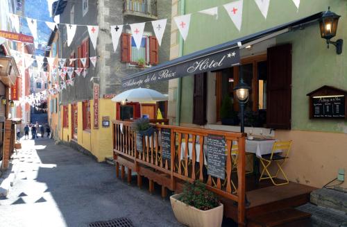 a restaurant with a table outside of a building at Auberge de la Paix in Briançon