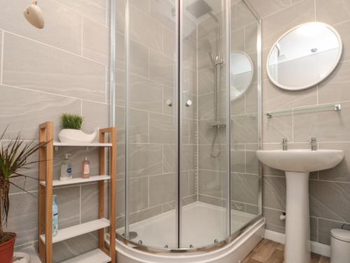 a bathroom with a shower and a sink at Chestnut Cottage in Scarborough