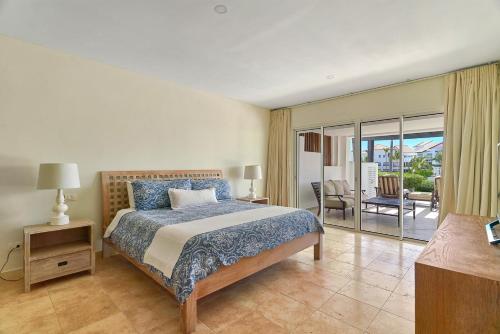 a bedroom with a bed and a view of a patio at Relax Beach Condo W Private Pool And Beach! in Punta Cana