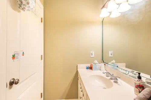 a bathroom with a sink and a mirror and a shower at City Chic Private Room & Bath in Atlanta