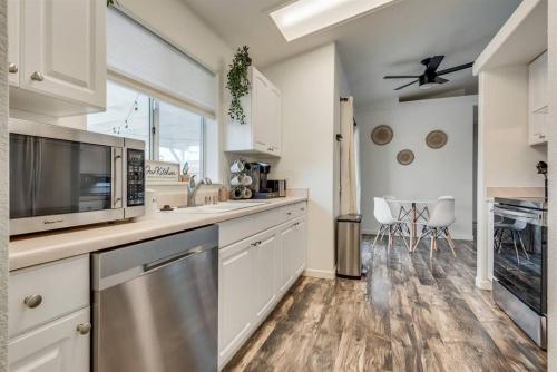 a kitchen with white cabinets and a stainless steel appliance at Family Friendly Home w/ Backyard Games, RV Parking in Lake Havasu City