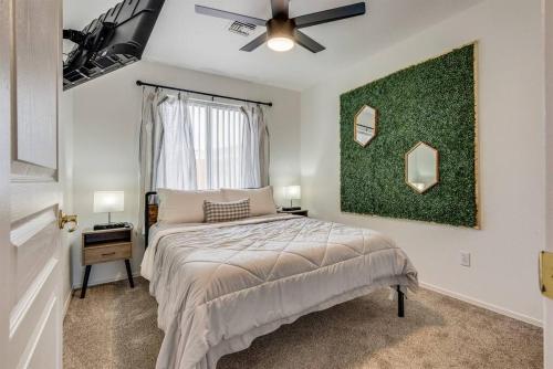 a bedroom with a bed and a green wall at Family Friendly Home w/ Backyard Games, RV Parking in Lake Havasu City