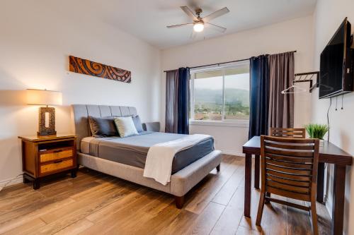 a bedroom with a bed and a desk and a window at Unit 6 Maui Ohana Modern Studio in Wailuku