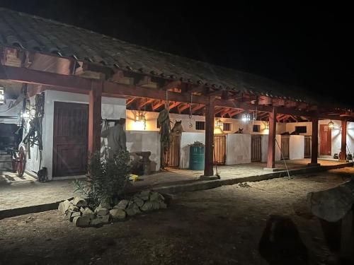 a man standing outside of a house at night at CASONA SAN PEDRO Hotel Boutique in San Javier
