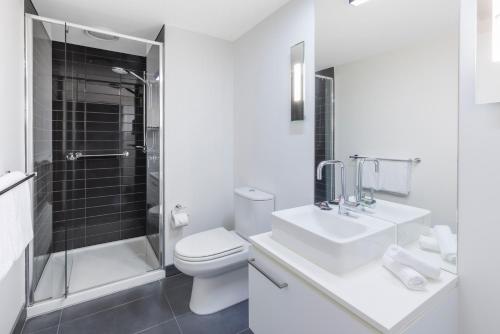 a bathroom with a toilet and a sink and a shower at Naima Hotel in Melbourne