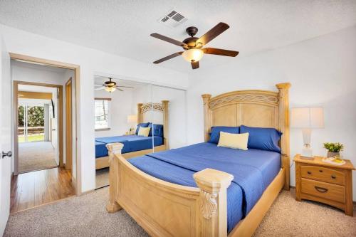 a bedroom with a bed and a ceiling fan at Centrally located Spacious Vacation Hom 13 m strip in Las Vegas