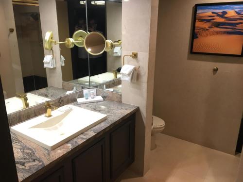 a bathroom with a sink and a toilet and a mirror at Strip Las Vegas Unit by Luxor and T Mobile arena area in Las Vegas