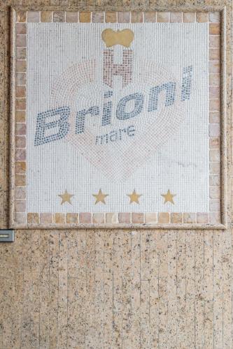 a mosaic of a train on the side of a wall at Hotel Brioni Mare in Lido di Jesolo