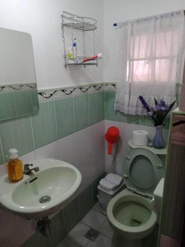 a bathroom with a toilet and a sink at Charming Getaway @ The City of Pines in Baguio