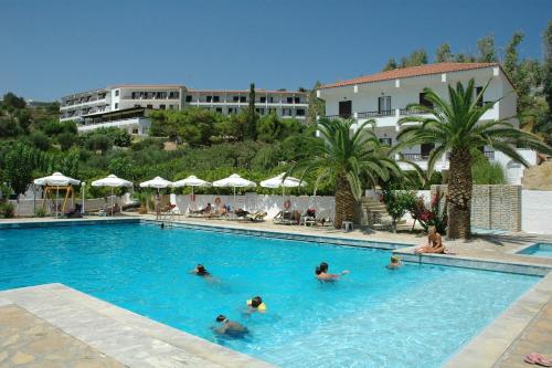 a group of people swimming in a swimming pool at Hotel Glicorisa Beach in Pythagoreio