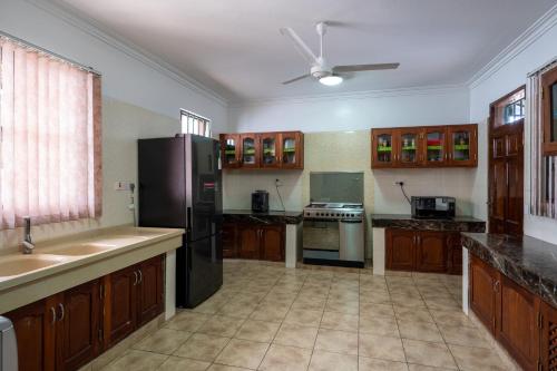 a kitchen with a black refrigerator and a sink at Nyali Villa in Mombasa