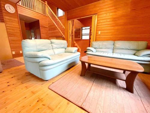 a living room with a couch and a coffee table at 飯能テラス in Hanno