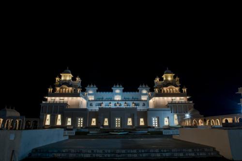 a lit up building at night at The Utopia Resort Sanchi in Sānchi