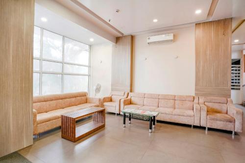 a living room with a couch and a table at Hotel Mahadev Residency - Dapode, Bhiwandi in Kolshet