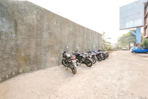 a row of motorcycles parked next to a wall at Hotel Mahadev Residency - Dapode, Bhiwandi in Kolshet