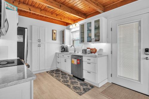 a kitchen with white cabinets and a counter top at Lisa Lu by Oak Island Accommodations in Oak Island