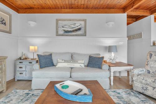 a living room with a couch and a table at Lisa Lu by Oak Island Accommodations in Oak Island