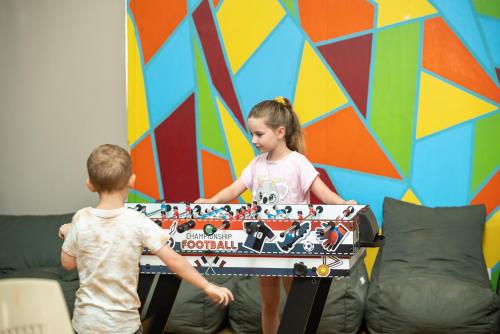 a boy and a girl playing with a toy piano at Ingenia Holidays Murray Bend in Koonoomoo