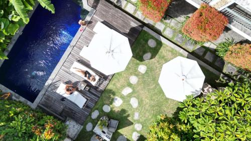 an overhead view of a garden with a pool at THE SPARE ROOM BALI in Canggu