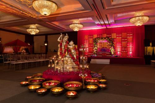a room with a table with candles and a red wall at InterContinental Cleveland by IHG in Cleveland