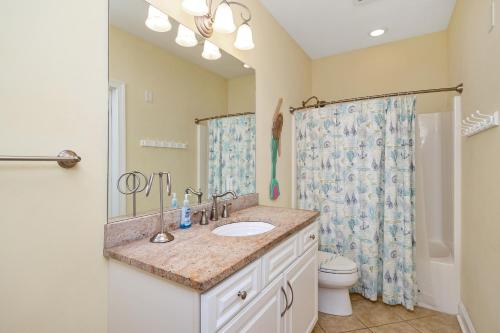 a bathroom with a sink and a toilet and a shower at The Dunes in Oak Island