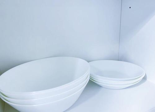 two white bowls are sitting on a shelf at Beacon Executive Suites #Georgetown #RoofTopPool #Spacious #13a in George Town