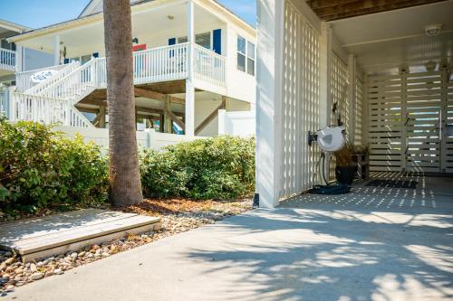 a porch of a beach house with a house at The Anchor Holds by Oak Island Accommodations in Oak Island
