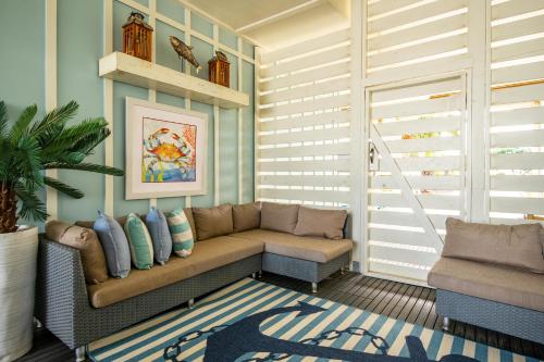 a living room with a couch and a chair at The Anchor Holds by Oak Island Accommodations in Oak Island