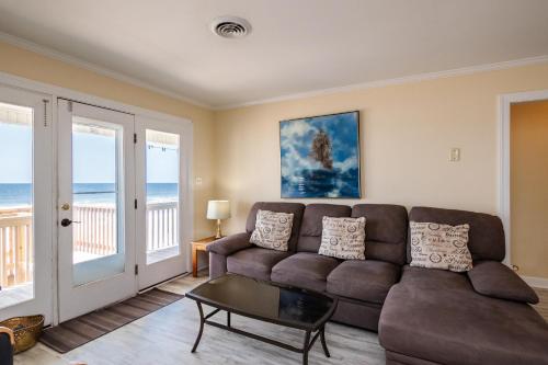 a living room with a couch and a table at Absolute Beach by Oak Island Accommodations in Oak Island