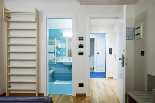 a bathroom with a staircase and a bathroom with a sink at Hotel Sporting in San Benedetto del Tronto