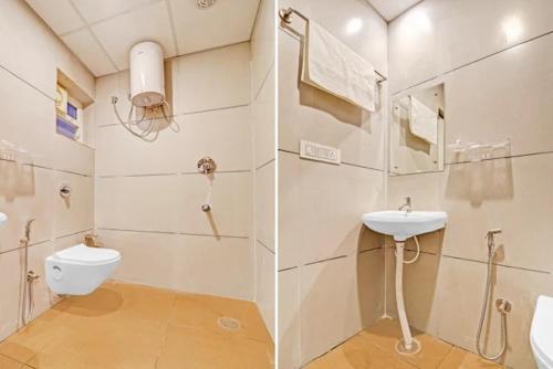 a white bathroom with a sink and a toilet at Sri Udupi park phoenix mall in Bangalore