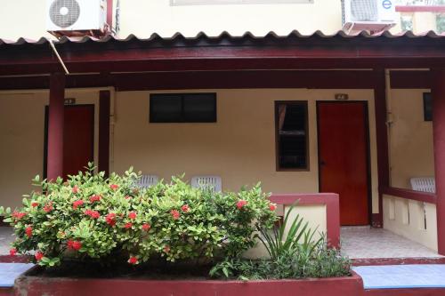 a house with red flowers in front of it at Island View Bungalows in Choeng Mon Beach