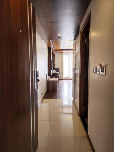 a hallway of an office building with a hallway at Hotel Preethi International in Mysore