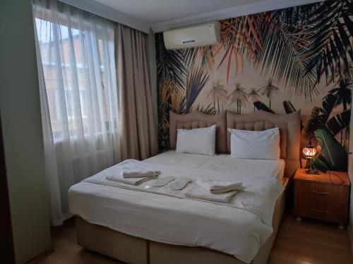 a bedroom with a bed with two towels on it at Seyri Istanbul Hotel in Istanbul